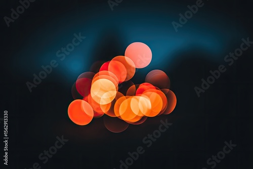 Abstract bokeh of vibrant orange and red lights against a dark background