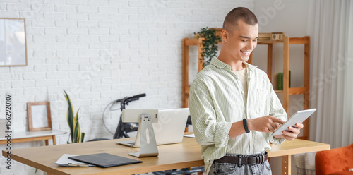 Young man working with tabl...
