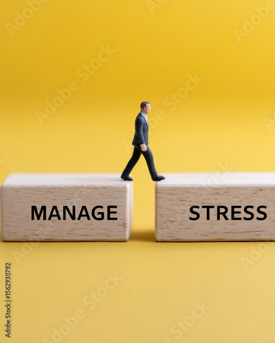 Wallpaper Mural  two wooden blocks labeled "MANAGE" and "STRESS", with silhouette of a man walking across, concept of bridging stress with solutions, yellow backgrou Torontodigital.ca