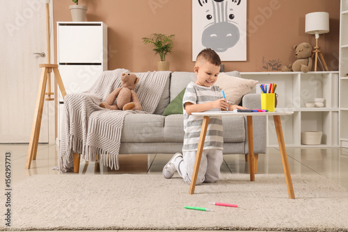 Adorable little boy drawing...