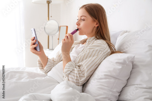 Young woman using mobile ph...