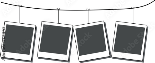 Four blank polaroid frames hang from a string, isolated on white background, blank photo frames on black