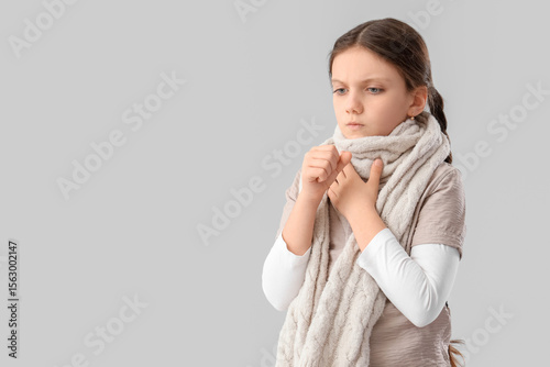 Sick girl with scarf coughi...