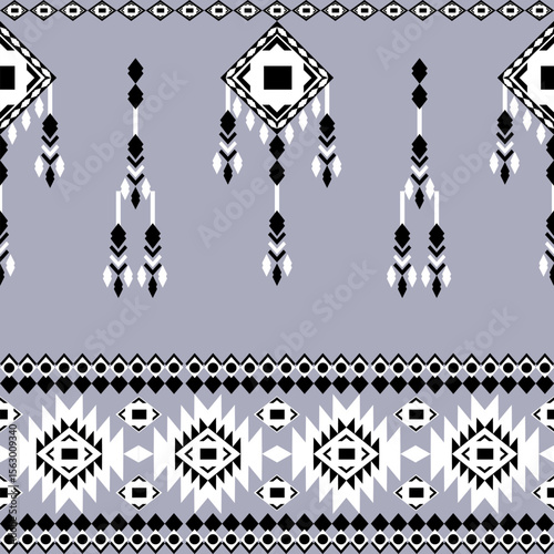 Black and white geometric ethnic boho seamless pattern on a grey background. Native ethnic pattern. Tribal pattern. Aztec-style. Textile rapport. Ideas for wallpaper, tiles, and elaborate borders.