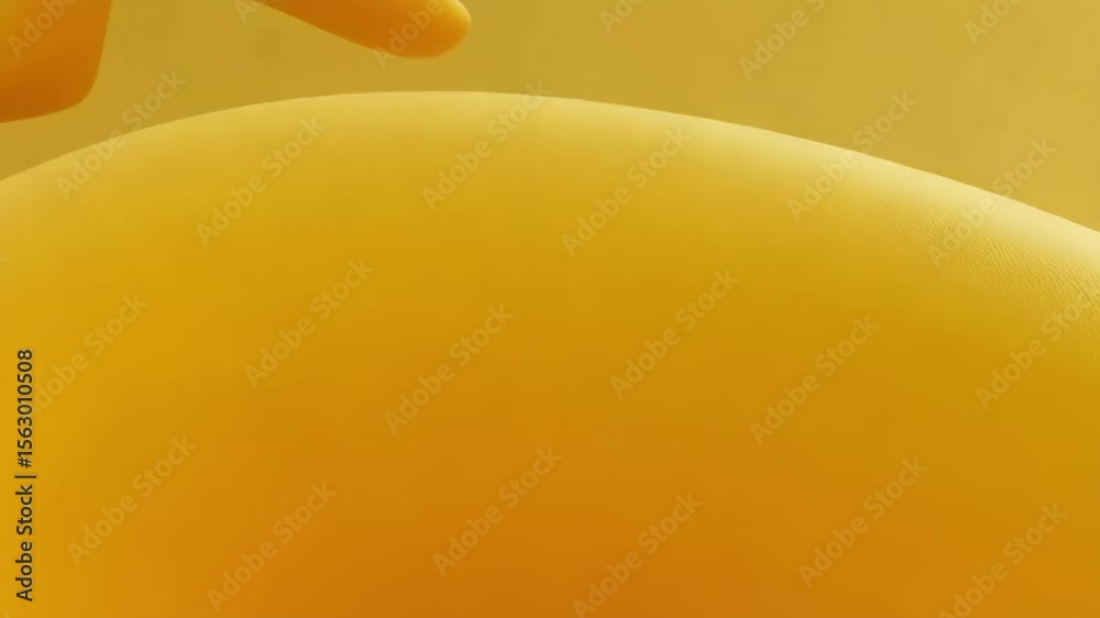 A flowing yellow abstract sculpture features two spherical elements against a matching backdrop