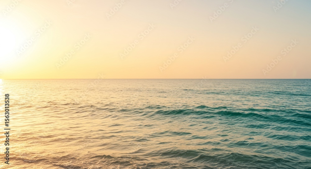 Fototapeta premium Creamy cream to tropical turquoise gradients with calm waves reflecting golden sunlight.