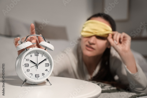 Young woman with sleep mask...