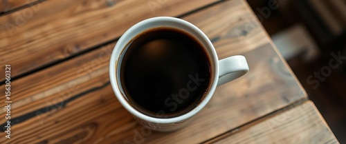 Dark, rich long black coffee in a white cup on a rustic wooden cafe table,  brown,  cafe
