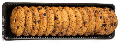 Crispy chocolate chip cookies in a black tray with goldbrown color and textured surface, delicious baked snack for sweet cravings