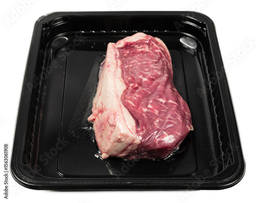 Fresh marbled striploin steak in vacuumpack plastic tray isolated on black background, premium quality beef cut highlighting tenderness and rich flavor, raw meat essence