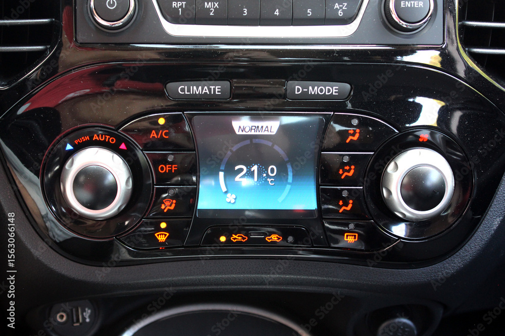 Fototapeta premium Automatic climate control with a temperature of 21 degrees. Car air conditioning on minimum cold setting. Detail interior of vehicle. Air conditioning of a modern car. Vehicle Conditioner.