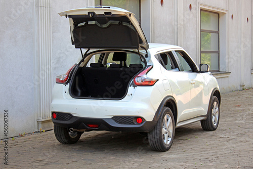 New white SUV open trunk. Modern electric car trunk.Vehicle is ready to load luggage. Modern car SUV with open empty trunk. Modern wagon car open trunk. Car boot is open.