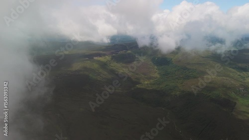 Spectacular 4K aerial video of flying above picturesque mountains just under clouds, Wicklow mountains, Ireland