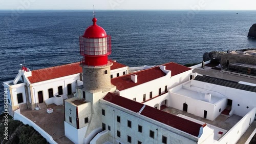 Explore Portugals Algarve coastline and the iconic red lighthouse at Cape St. Vincent near Sagres