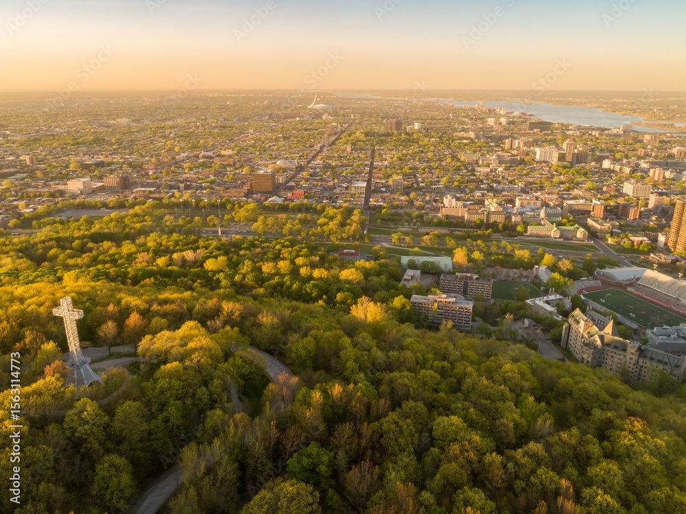 Obraz premium Aerial view of the Mount Royal Cross atop Mount Royal, overlooking Montreal, Canada. The cross is a landmark and symbol of the city, attracting tourists and locals alike.