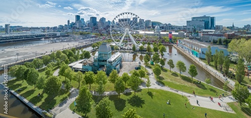 Aerial view of La Grande Roue de Montréal, a Ferris wheel in the Old Port of Montreal, Canada. Tourists visit to enjoy the views of the city skyline.
