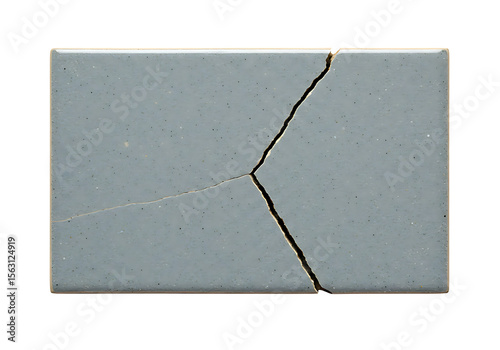 Cracked gray ceramic tile showing fragmentation and a linear split, ideal for representing breakage, damage, or texture.