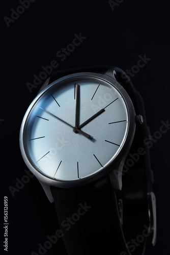 Minimalist Silver Wristwatch with Black Strap on Dark Background