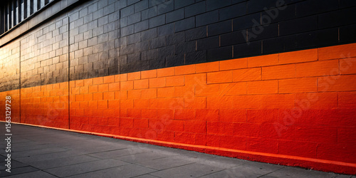 Vibrant orange-red brick wall with gradient color scheme transitioning from gray to bright orange, showcasing modern masonry design and architectural color blocking.