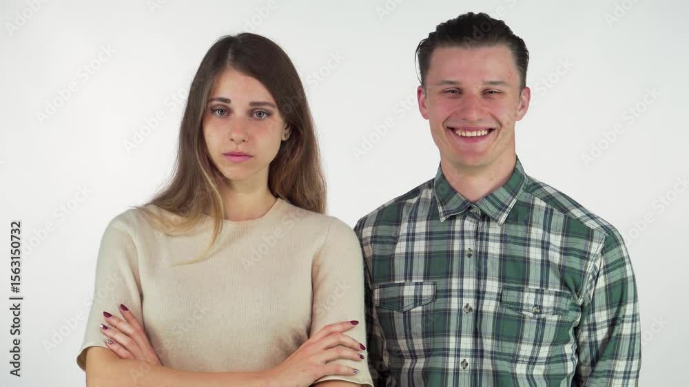 Cheerful man playfully laughing at his annoyed girlfriend, isolated Cheerful man playfully laughing at his annoyed girlfriend, isolated
