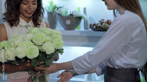 Florist presents a stunning bouquet to a young woman