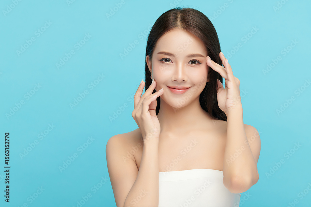 A beautiful young Asian woman with clean, fresh skin against a blue background. Skincare, facial treatment, cosmetology, beauty, and spa. An elegant portrait of an Asian woman. A beautiful young Asian woman with clean, fresh skin against a blue background. Skincare, facial treatment, cosmetology, beauty, and spa. An elegant portrait of an Asian woman.