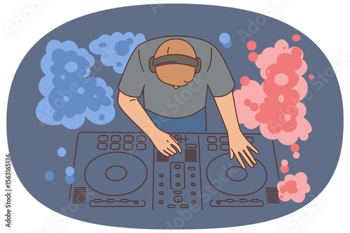 Nightclub DJ uses mixing console to play music from vinyl records to party goers