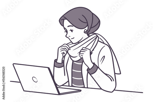 A young woman wearing a hijab adjusts her scarf while working on a laptop computer at a desk