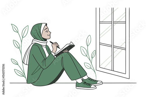 A muslim woman wearing a green hijab and outfit sits by a window thoughtfully journaling in a notebook with a pen