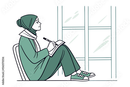 Young muslim woman wearing a hijab and casual clothing sits by a window thoughtfully writing in a notebook with a pen