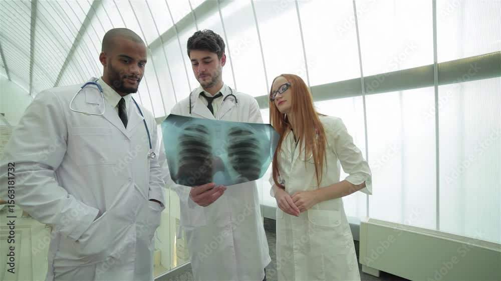 Doctors analyzing lung X-ray to highlight smoking dangers Doctors analyzing lung X-ray to highlight smoking dangers