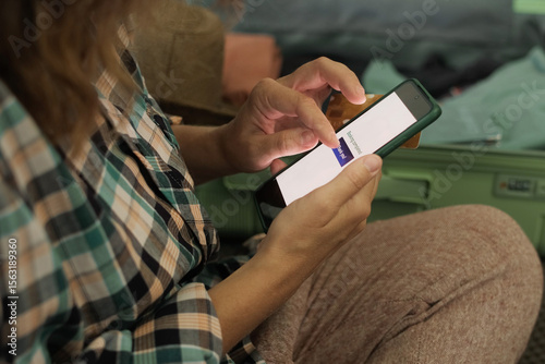 Travel planning. Person booking tour using smartphone. Online payment for last minute tour. 