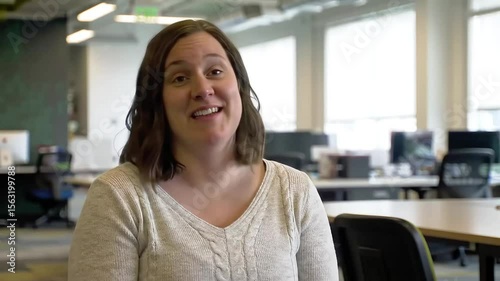 Enthusiastic woman sharing expertise in modern office workspace