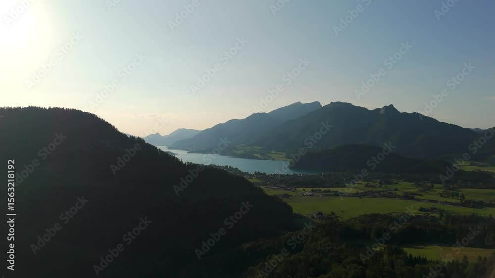 Lake Wolfgangsee, Strobl village and Salzburg Alps aerial drone view during golden hour, alpine valley and mountain silhouettes in Austria’s lake. Lake Wolfgangsee, Strobl village and Salzburg Alps aerial drone view during golden hour, alpine valley and mountain silhouettes in Austria’s lake.