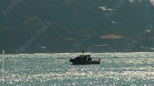 Silhouette of a small fishing boat in the Bosphorus
