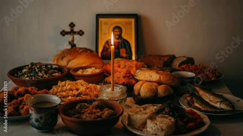 Traditional Eastern European feast with bread, fish, and religious icon