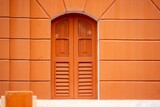 Orange Arched Window on Textured Wall