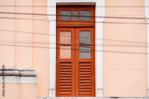 Burnt orange wooden door with glass panels