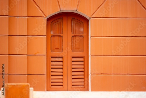 Orange Arched Window on Textured Wall