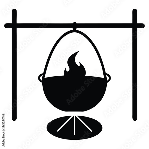 Silhouette of a black cauldron with fire hanging over a tripod cooking