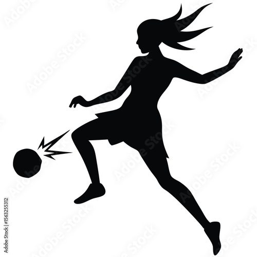 Silhouette of a female soccer player kicking a ball football