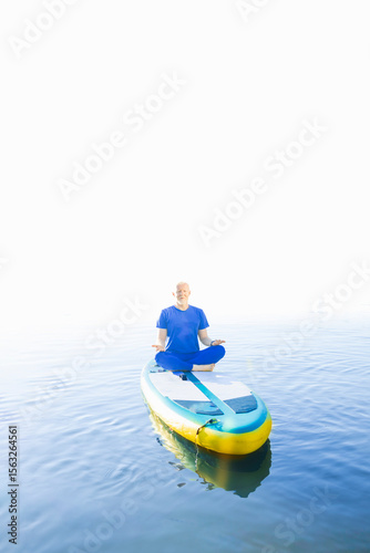 A man practicing mindfulness travel on his SUP board.