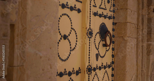 Close up architectural door in old ancient city of Sousse. Colorful textured door of muslim architecture.