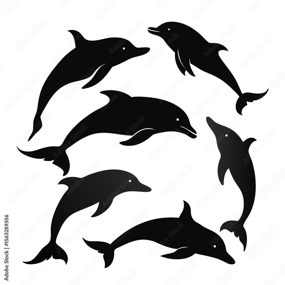 Fototapeta premium Silhouettes of playful dolphins leaping and swimming in the ocean