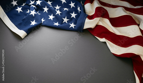 Photography American flag draped elegantly on a dark gray surface for a patriotic display