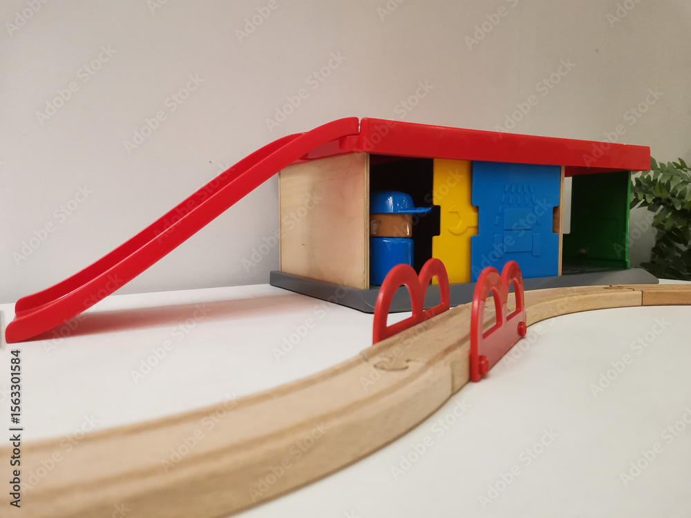 Naklejka premium Wooden Train Set with Station and Bridge. Children's toys, inviting imaginative play and adventure.