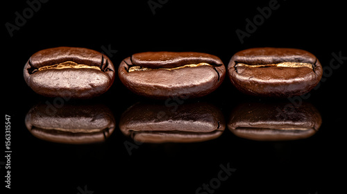 Coffee Bean Trio: A set of three polished coffee beans in a line, exhibiting rich color and a deep mirror like reflection.