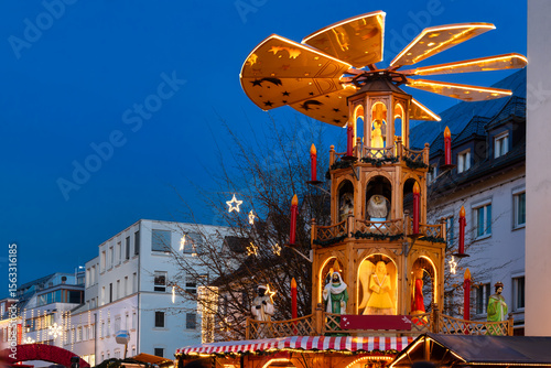 Traditional Christmas market with lights, wooden stalls and Christmas pyramid in downtown Bregenz, Lake Constance, Austria