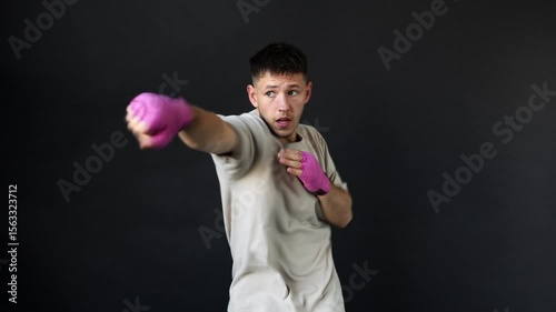 Boxer practices punches in training session in gym studio