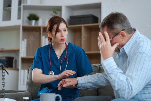 doctor talking with man patient for monitoring and check up. doctor touching patient hand and consoling.